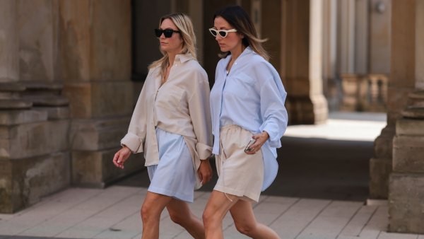 HAMBURG, GERMANY - AUGUST 16: Anne Philine (L) seen wearing black Celine sunglasses, a creme beige shirt from SohoStudios, light blue SohoStudios shorts and creme white suede Birkenstock Arizona sandals; Elise Seitz (R) seen wearing white Celine sunglasses, a light blue SohoStudios shirt, a creme beige shorts from SohoStudios and beige suede Birkenstock Boston sandals, on August 16, 2022 in Hamburg, Germany. (Photo by Jeremy Moeller/Getty Images)