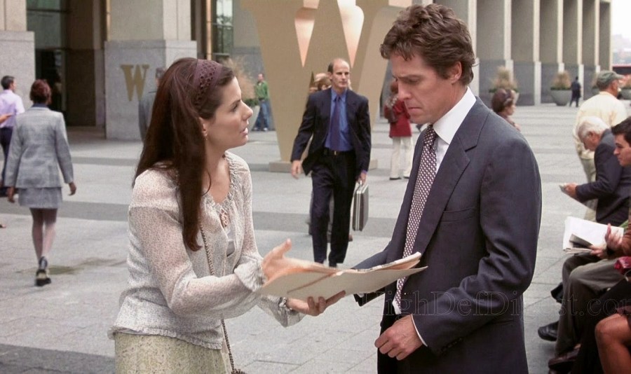 A woman and a man talk outside in Two Weeks Notice.