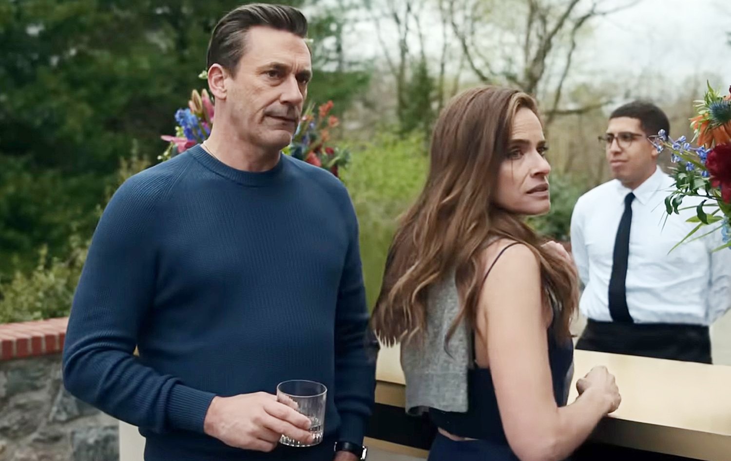 A man and a woman stand next to each other in Your Friends & Neighbors.