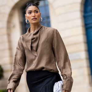 PARIS, FRANCE - MARCH 04: Pritika Swarup, wearing a brown blusa, white shoes and black fringes pants, is seen on the streets of Paris, during Paris Fashion Week - Womenswear F/W 2022-2023 on March 04, 2022 in Paris, France. (Photo by Claudio Lavenia/Getty Images)