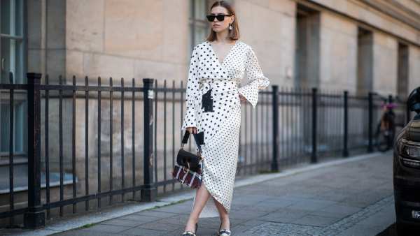Swantje Sömmer is seen wearing white dress with black dots print Mother of Pearl, JW Anderson plaid bag, Prada shoes in black and white, Ray Ban sunglasses on June 05, 2019 in Berlin, Germany.
