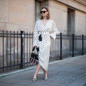 Swantje Sömmer is seen wearing white dress with black dots print Mother of Pearl, JW Anderson plaid bag, Prada shoes in black and white, Ray Ban sunglasses on June 05, 2019 in Berlin, Germany.