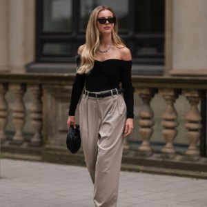 HAMBURG, GERMANY - AUGUST 29: Isabelle Hartmann is seen wearing Bottega Veneta mini Jodie black leather bag, Saint Laurent black silver heels, Edited x Isabelle Hartmann wide leg beige pants, Filippa K black silver leather belt, Khaite black off shoulder top, Tiffany & Co City Hardwear silver chain and Saint Laurent black shades on August 29, 2022 in Hamburg, Germany. (Photo by Jeremy Moeller/Getty Images)
