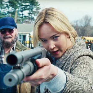 A woman aims a shotgun in 'Joy.'