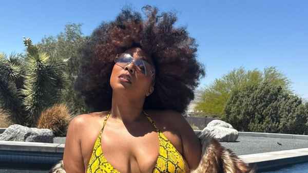 Lizzo Has Major Mom Wife Moment in Sexy Bikini and Fur Coat