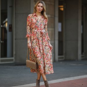 DUSSELDORF, GERMANY - MARCH 24: Scarlett Gartmann wearing Mango flower dress, beige Chanel Boy bag and brown Kennel & Schmenger leather boots on March 24, 2021 in Dusseldorf, Germany. (Photo by Jeremy Moeller/Getty Images)