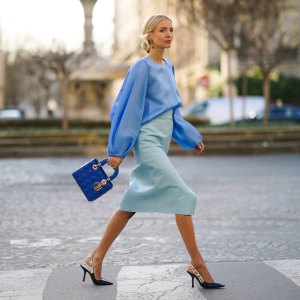 PARIS, FRANCE - JANUARY 21: Leonie Hanne wears a blue silky lustous blouse with puff sleeves, a blue quilted Lady Dior bag, a pale blue leather skirt, Dior pointy shoes, during Paris Fashion Week - Haute Couture Spring/Summer 2020, on January 21, 2020 in Paris, France. (Photo by Edward Berthelot/Getty Images )