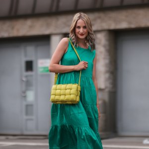 HAMBURG, GERMANY - JUNE 03: Louisa Theresa Grass wearing green Zero Fashion midi dress, yellow Bottega Veneta leather bag and white Hermes slides on June 03, 2021 in Hamburg, Germany. (Photo by Jeremy Moeller/Getty Images)