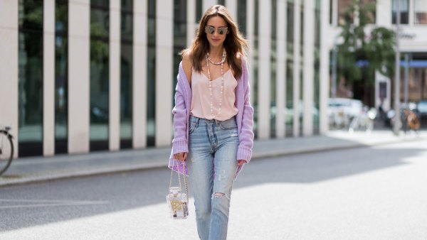 BERLIN, GERMANY - JULY 07: Alexandra Lapp wearing a purple cashmere cardigan by Heartbreaker, a rose tank top in silk from Jadicted, a high waist, non-strech denim, five-pocket 501 skinny jeans from Levis, a candy necklace from Chanel supermarket collection in pastel tones, a Chanel perfume bottle bag in plexiglass and a golden chain with white leather, Christian Louboutin pumps Feerica with nude mesh upper embedded with a Swarovski crystal degrade and Karl Lagerfeld cat-eye sunglasses in the shape of cat ears during the Mercedes-Benz Fashion Week Berlin Spring/Summer 2018 on July 7, 2017 in Berlin, Germany. (Photo by Christian Vierig/Getty Images)