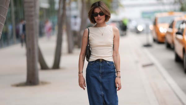 MIAMI, FLORIDA - DECEMBER 08: Michelle Fleur seen wearing Saint Laurent black sunglasses, cream white sleeveless top, gold letter necklace, Louis Vuitton brown canvas logo pattern belt, dark blue denim / jeans long skirt, Bottega Veneta black leather purse / shoulder bag, Cartier Panthère silver / gold bi-color watch, on December 08, 2023 in Miami, Florida. (Photo by Jeremy Moeller/Getty Images)