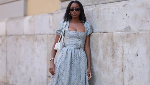 MUNICH, GERMANY - SEPTEMBER 21: Noutcha Lopes is seen wearing narrow rectangular sunglasses with a rounded black frame from Saint Laurent; chunky gold hoop earrings; a light blue dirndl with a flower pattern, a balconette neckline, a button placket, puffy short sleeves, and a bow from Limberry; a watch in silver and gold from Cartier; the yellow gold “Juste un Clou“ bracelet and ring from Cartier; a black bracelet with a blue eye pendant; and a rectangular white leather “Le Teckle“ bag with tubular handles from Alaïa during the opening day of the 2024 Munich Oktoberfest on September 21, 2024 in Munich, Germany. This year's Oktoberfest will run through October 6 and is expected to draw millions of visitors. (Photo by Jeremy Moeller/Getty Images)
