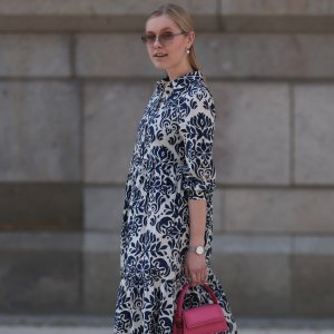 HAMBURG, GERMANY - JUNE 08: Lil Paulin seen wearing a darkblue and white flower printed long dress, pink mini handbag, Emporio Armani brown big shades, Daniel Wellington silver watch, Superga navy blue sneaker and silver pearls earrings and rings on June 08, 2023 in Hamburg, Germany. (Photo by Jeremy Moeller/Getty Images)
