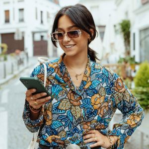 Fashionable millennial woman with sunglasses in city of Paris - stock photo