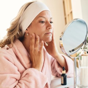 Beautiful woman taking care of her skin - stock photo