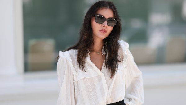 Milena Karl is seen wearing black sunglasses from Chanel, earrings from Bottega Veneta, a gold necklace, a a white shirt with puffy sleeves, black shorts from Chloe, gold and silver rings on August 22, 2023 in Hamburg, Germany.