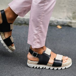 MILAN, ITALY - SEPTEMBER 18: A guest wears light pink pants, black and beige flat sandals, outside the Prada show during Milan Fashion Week Spring/Summer 2020 on September 18, 2019 in Milan, Italy. (Photo by Edward Berthelot/Getty Images)