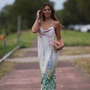 DUSSELDORF, GERMANY - JULY 22: Bruna Rodrigues is seen wearing a pastel coloured midi dress with watercolour print from Riani, a pink bag and pink strap sandals outside during the Riani Cruise 2023 on July 22, 2023 in Dusseldorf, Germany. (Photo by Jeremy Moeller/Getty Images)
