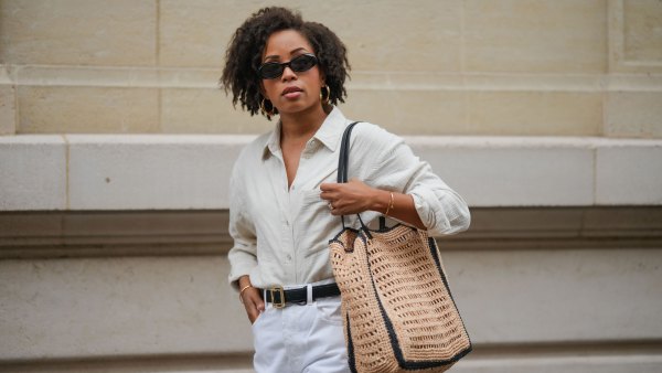 PARIS, FRANCE - MAY 08: Ellie Delphine wears a full Mango look, sunglasses, golden earrings, a white linen shirt, a black leather belt with golden buckle, golden bracelets, a white ripped denim shorts, a large brown raffia bag, during a street style fashion photo session, on May 08, 2024 in Paris, France. (Photo by Edward Berthelot/Getty Images)
