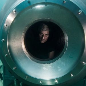 A man looks out on the ocean in Titan: The OceanGate Disaster