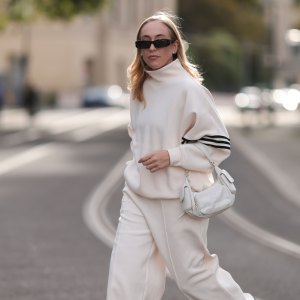 Sonia Lyson seen wearing Linda Farrow black sunglasses, Adidas white two-piece / white logo cotton oversized sweater and matching white wide leg pants, Miu Miu white leather Pocket bag, Copenhagen Studios white with black details leather sneakers, on September 03, 2023 in Berlin, Germany. (Photo by Jeremy Moeller/Getty Images)
