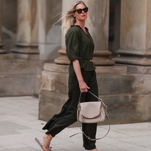 Vanessa Gieser seen wearing a brown Celine sunglasses, khaki blouse from SoSue, a matching khaki pants from SoSue, a beige leather Tom Ford bag, a black Celine belt and beige Valentino sandals on June 09, 2022 in Hamburg, Germany.
