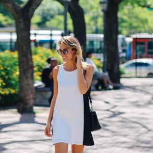 Woman smiling and enjoying the sun while strolling in the park, Buenos Aires, Argentina.