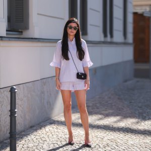 BERLIN, GERMANY - JULY 28: Leo Eberlin is seen wearing Sleeper lilac pastel mini shorts and Sleeper blouse, Chanel pink tweed heels, Chanel mini bag and & other stories shades on July 28, 2022 in Berlin, Germany. (Photo by Jeremy Moeller/Getty Images)
