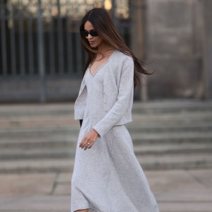 BERLIN, GERMANY - NOVEMBER 04: Jill Asemota seen wearing black vintage sunglasses, Dorothee Schumacher grey wool knit long dress, matching Dorothee Schumacher grey wool knit cardigan jacket, white cotton socks, Adidas white leather Samba sneakers, on November 04, 2023 in Berlin, Germany. (Photo by Jeremy Moeller/Getty Images)