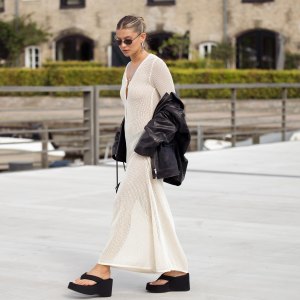 COPENHAGEN, DENMARK - AUGUST 08: Sophia Geiss wears a long beige knitted maxi dress, black flip flops, sandals, leather jacket and black bag during day four of the Copenhagen Fashion Week (CPHFW) SS25 on August 08, 2024 in Copenhagen, Denmark. (Photo by Raimonda Kulikauskiene/Getty Images)