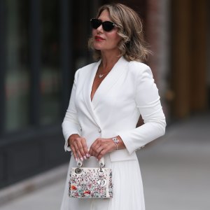 NEW YORK, NEW YORK - SEPTEMBER 07: Olga Ferrara seen wearing diamond studded black sunglasses, Leibish diamond necklace and bracelet, Milly white elegant blazer short dress and Dior white leather / colorful rhinestones pattern embroidered handbag, during the New York Fashion Week, on September 07, 2024 in New York City. (Photo by Jeremy Moeller/Getty Images)