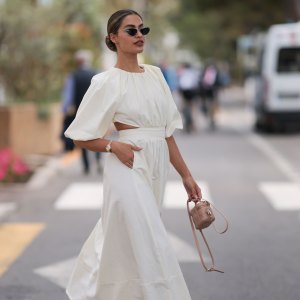 CANNES, FRANCE - MAY 21: Jessica de Oliviera seen wearing Dior black sunglasses, Dior bag, Chanel heels, Rolex yellow gold watch and a flowy long dress with cutouts during the 76th Cannes film festival on May 21, 2023 in Cannes, France. (Photo by Jeremy Moeller/Getty Images)