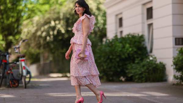Anna Wolfers wearing white and pink ruffle dress via Goldig Shop, pink Moschino clutch and pink heels on May 31, 2021 in Hamburg, Germany.