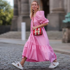 Sonia Lyson wearing Louis Vuitton bag, white Dior ID sneakers and pink H&M maxi dress on July 06, 2021 in Berlin, Germany.