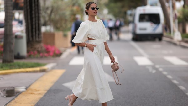 Jessica de Oliviera seen wearing Dior black sunglasses, Dior bag, Chanel heels, Rolex yellow gold watch and a flowy long dress with cutouts during the 76th Cannes film festival on May 21, 2023 in Cannes, France.