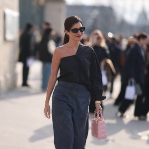 Gilda Ambrosio is seen wearing a black oneshoulder top, grey denim pants, pink Dior bag, black sunglasses outside Christian Dior during the Womenswear Fall/Winter 2024/2025 as part of Paris Fashion Week on February 27, 2024 in Paris, France.