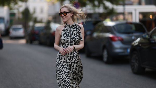 BERLIN, GERMANY - JUNE 19: Lil Paulin is seen wearing oversized black square-framed sunglasses with orange lenses and wide temples, gold hoop earrings, a flowy sleeveless maxi dress with a halter neck and a geometric black and white pattern, a gold rectangular watch from Daniel Wellington, and several filigree silver rings on June 19, 2025 in Berlin, Germany. (Photo by Jeremy Moeller/Getty Images)