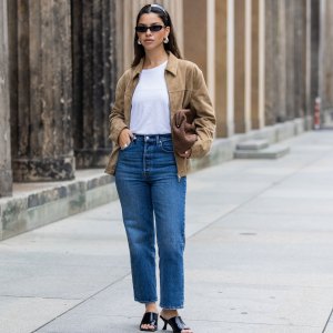BERLIN, GERMANY - JULY 01: Bella Emar wears Levi’s blue denim jeans, white Cos t-shirt, brown Massimo Dutti Jacket, black H&M Heels, Mango sunglasses during the Berlin Fashion Week SS25 on July 01, 2024 in Berlin, Germany. (Photo by Christian Vierig/Getty Images)