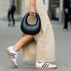 BERLIN, GERMANY - MAY 05: Jacqueline Zelwis wears sleevelss white 7forallmankind top, beige Herskind skirt, white Adidas sneakers, black Charles & Keith bag on May 05, 2024 in Berlin, Germany. (Photo by Christian Vierig/Getty Images)