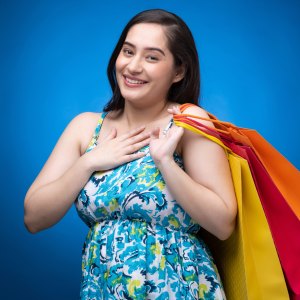 Portrait of young woman wear dress isolated on blue background