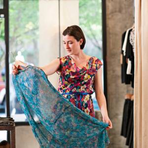 Woman in a floral dress admires another floral dress