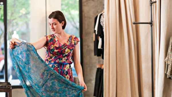 Woman in a floral dress admires another floral dress