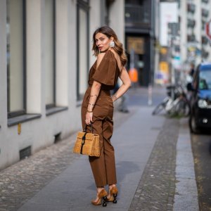 BERLIN, GERMANY - MAY 11: Masha Sedgwick is seen wearing ripped off brown overall Max Mara, clip earrings Mango, Coccinelle straw bag, Jacquemus shoes, on May 11, 2019 in Berlin, Germany. (Photo by Christian Vierig/Getty Images)