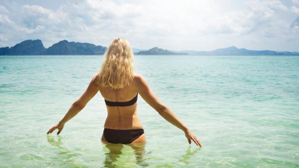 mature woman on holiday, on her way into the ocean, snorkeling, Koh Kradan, Thailand