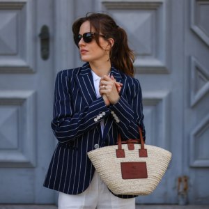 MUNICH, GERMANY - MAY 10: Cleo zu Oettingen-Spielberg wearing navy blue striped Polo Ralph Lauren jacket, white polo and white linen pants and beige Loewe bag via Lodenfrey SS21 on May 10, 2021 in Munich, Germany. (Photo by Jeremy Moeller/Getty Images)