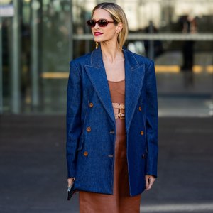 Helena Bordon wears denim blazer, brown dress, sunglasses, golden earrings outside Zimmermann during the Womenswear Fall/Winter 2024/2025 as part of Paris Fashion Week on March 04, 2024 in Paris, France.