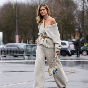 PARIS, FRANCE - JANUARY 28: Xenia Adonts wears silver necklace, light gray oversized Chanel tweed cardigan, light brown suede belt, light gray baggy Chanel tweed pants, light yellow transparent Chanel bag, outside Chanel, during the Haute Couture Spring/Summer 2025 on January 28, 2025 in Paris, France. (Photo by Edward Berthelot/Getty Images)