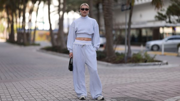 MIAMI, FLORIDA - DECEMBER 08: Lena Gercke seen wearing Saint Laurent black sunglasses, silver statement necklace, Alexander Wang light grey high neck cotton cropped jumper / sweater, Alexander Wang light grey cotton wide leg jogger pants with underwear detail, Saint Laurent black varnishes leather mini bag and Axel Arigato white leather sneakers, on December 08, 2023 in Miami, Florida. (Photo by Jeremy Moeller/Getty Images)2