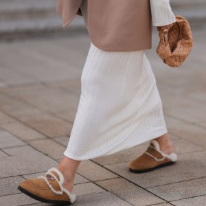 COLOGNE, GERMANY - AUGUST 22: Julia Zwingenberg wearing Christian Dior beige cat eye shades, beige oversized Acne Studios blazer, creme white long by Aylin Koenig dress, Bottega Veneta beige leather mini Jodie bag and Prada beige fur slip shoes on August 22, 2022 in Cologne, Germany. (Photo by Jeremy Moeller/Getty Images)