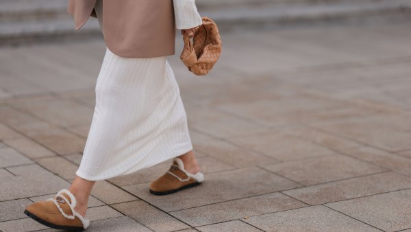 COLOGNE, GERMANY - AUGUST 22: Julia Zwingenberg wearing Christian Dior beige cat eye shades, beige oversized Acne Studios blazer, creme white long by Aylin Koenig dress, Bottega Veneta beige leather mini Jodie bag and Prada beige fur slip shoes on August 22, 2022 in Cologne, Germany. (Photo by Jeremy Moeller/Getty Images)