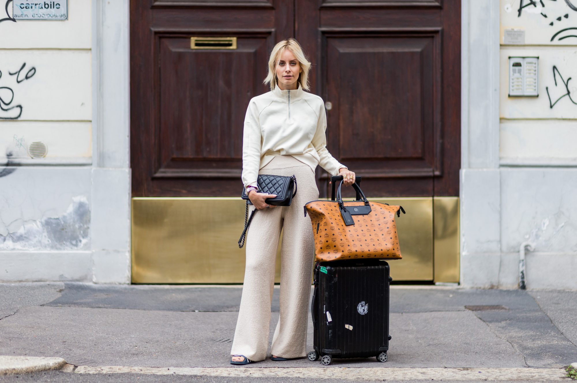 MILAN, ITALY - SEPTEMBER 22: Lisa Hahnbeuck (@lisarvd) wearing an Athleisure Look, Reebock sweater, Knit Pants Molli, bag Rimowa and MCM Nomad Travel Bag, Adiletten, Chanel Boy Bag outside Fendi during Milan Fashion Week Spring/Summer 2017 on September 22, 2016 in Milan, Italy. (Photo by Christian Vierig/Getty Images)